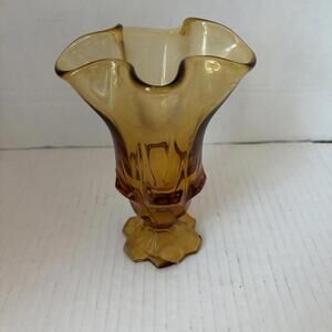 Vintage Fenton amber glass vase with a ruffled rim.